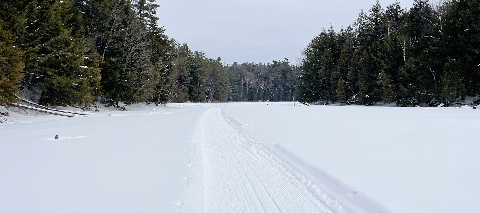Cross-country ski trail across frozen Redstone Lake at sunset