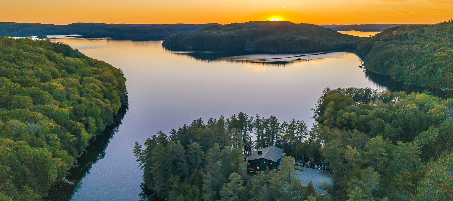 The home tucked into pines above twin docks and lakeside lounge